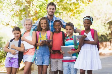 Teacher standing with school kids