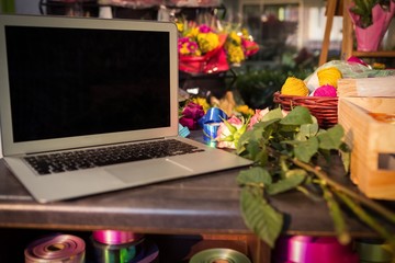 Laptop and florist supplies on the table