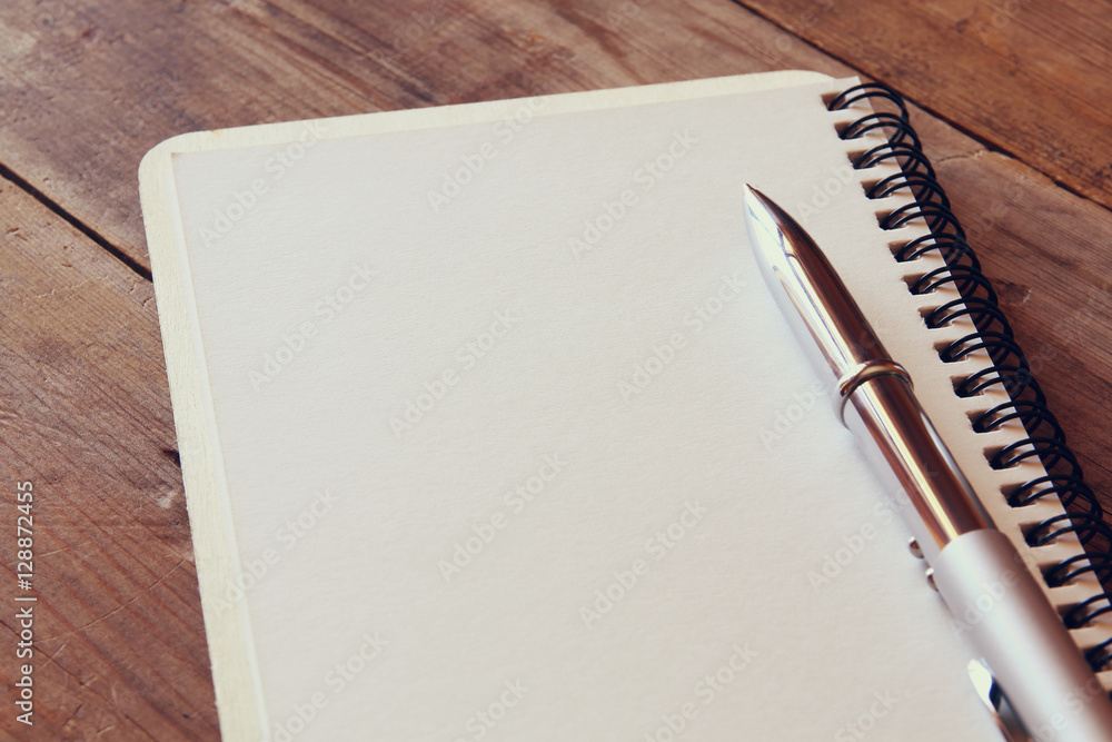 Poster top view image of open notebook with blank pages