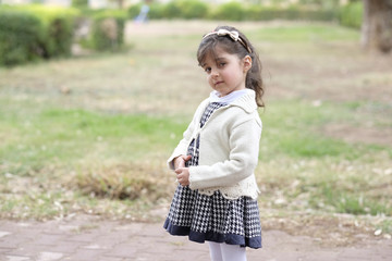 Small girl in kindergaten age standing outdoor in winter season