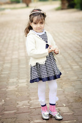 Fototapeta premium Small girl in kindergaten age standing outdoor in winter season