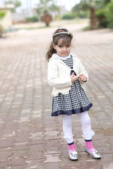 Small girl in kindergaten age standing outdoor in winter season