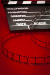 Cinema vintage celluloid filmstrip reel and movie clapper board used in retro film productions and cinematographic events