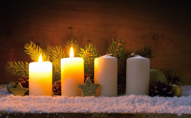 Two burning advent candles and Christmas decoration.
