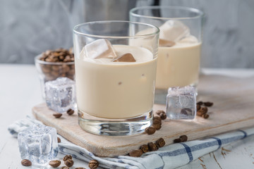 Coffee liqueur in glasses with ice and beans