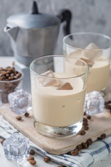 Coffee liqueur in glasses with ice and beans