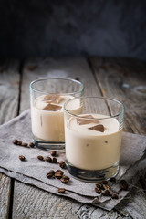 Coffee liqueur in glasses with ice and beans