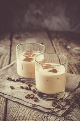 Coffee liqueur in glasses with ice and beans