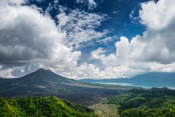 Caldera of the volcano of Batur at sunny day with clouds. Bali island, Indonesia