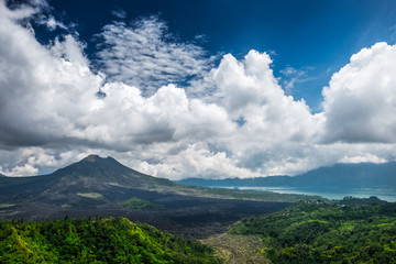 Obraz na płótnie Canvas Caldera of the volcano of Batur at sunny day with clouds. Bali island, Indonesia