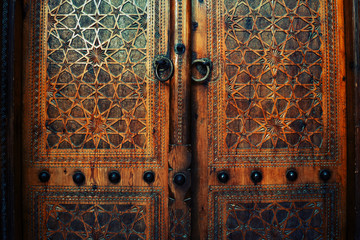 Grungy orintal texture on a wood. Door in one of Uzbekistans' mosque