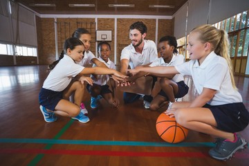 Basketball team  forming hand stack 
