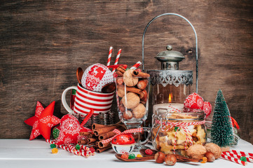 Christmas accessories,Vintage Lamps,Christmas decorations,gifts and decor for the New Year.Gingerbread cookies, nuts, cinnamon Sticks, Brown Wooden Background.