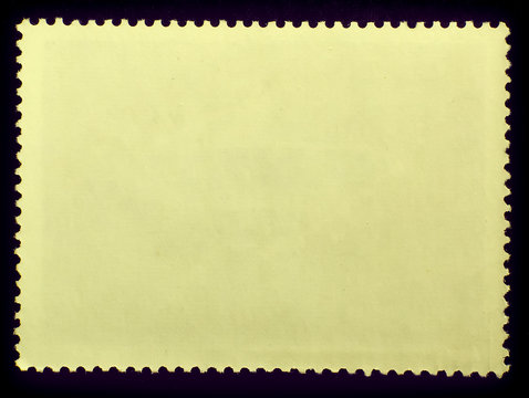 Posted stamp reverse  side with the edge of the sheet. Texture of paper.Isolated  on black background