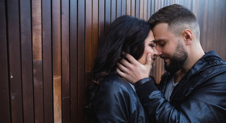 Couple in love - Beginning of a Love Story. A man and woman in evening dress, embrace and kiss while walking