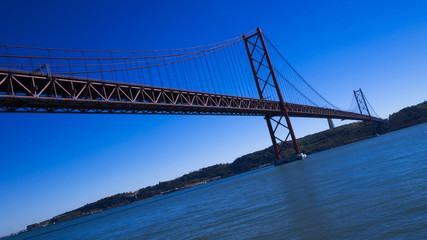 Fototapeta na wymiar Lisbon bridge which looks almost same like San Francisco Golden Gate Bridge