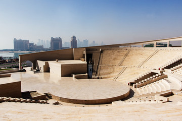 View of  modern amphitheatre in  Katara Cultural Village in Doha, Qatar  with skyscrapers in ...