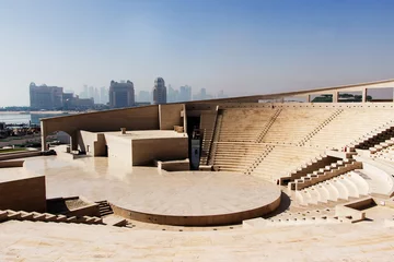 Photo sur Plexiglas Théâtre View of  modern amphitheatre in  Katara Cultural Village in Doha, Qatar  with skyscrapers in  background