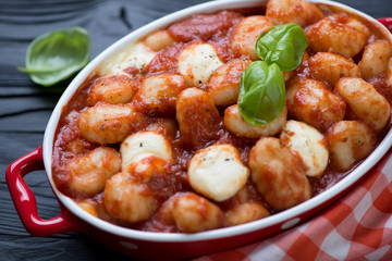 Closeup of potato gnocchi alla Sorrentina in a baking dish