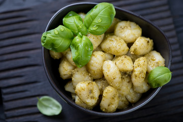 Close-up of boiled potato gnocchi with basil pesto sauce