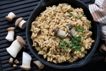 Closeup of a frying pan with porcini risotto, high angle view