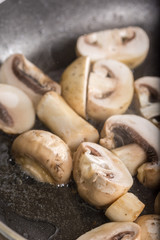 Frying sliced mushrooms in the frying pan
