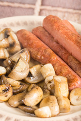 Fried sausages with sliced fried mushrooms