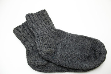 Knitted wool socks on a white background.