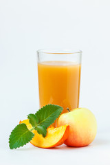 Full glass of fresh pumpkin juice with apples and mint isolated on white background