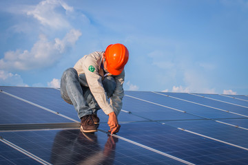 engineer or electrician working on  maintenance equipment at industry solar power;  engineer using thermal imager to check temperature heat of solar panel 