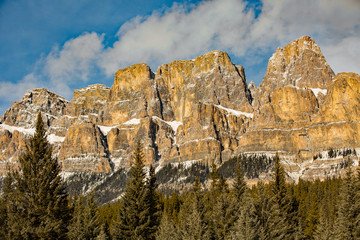 Rocky Moutain formation jagged peaks in winter with blue sky and clouds