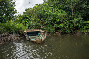 Broken boat on the shore of the river.