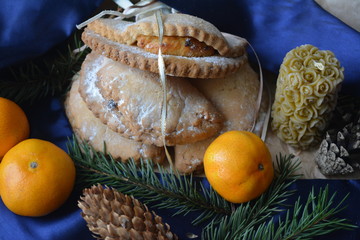beautiful winter composition: savory  biscuits, mandarins, sprigs of spruce, pine cone and candle, food, dessert