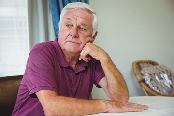 Senior man sitting at a table