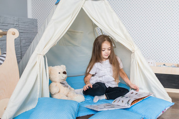 Child playing with a teepee tent © familylifestyle