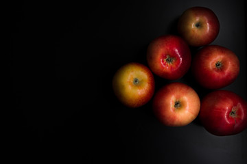 Fresh organic apples on a black background