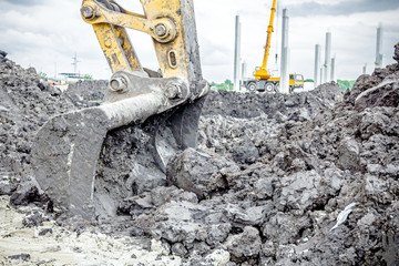 Excavator's tool, bucket, blade, cloudy sky behind