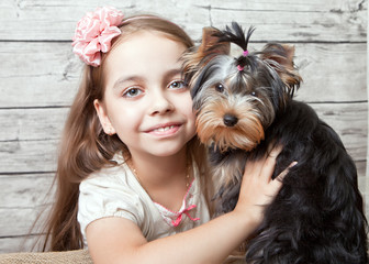 Girl with puppy of breed Yorkshire Terrier