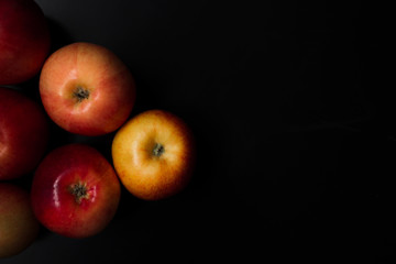 Fresh organic apples on a black background