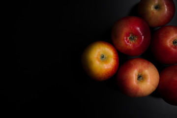 Fresh organic apples on a black background