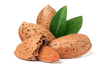 almonds in their skins and peeled with leaf isolated on white background