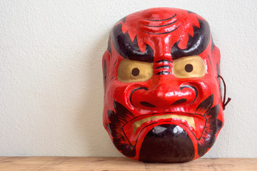 Angry red face of Noh mask