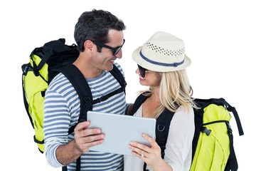 Cheerful couple holding digital tablet