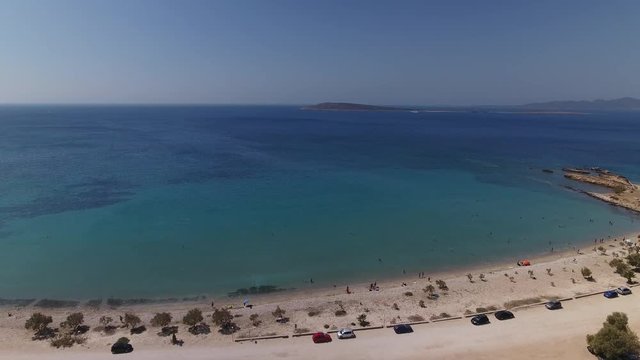 Aerial of small white beach and clear blue sea.