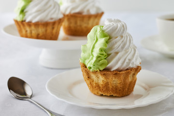 Air cake in a basket and coffee on a wooden background