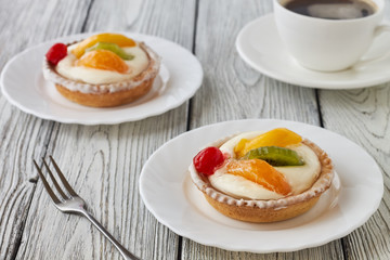 Tartlets with cream and fruits, orange, kiwi, cherry
