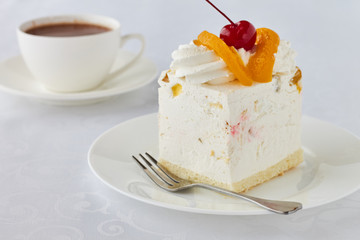 Cake dessert with peach, cherry and hot chocolate