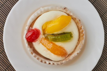 Tartlets with cream and fruits, orange, kiwi, cherry