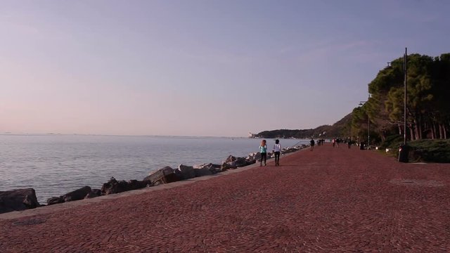 Couple of friend jogging next to the sea