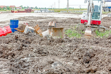 Arsenal of excavator's buckets on the ground, various sizes and